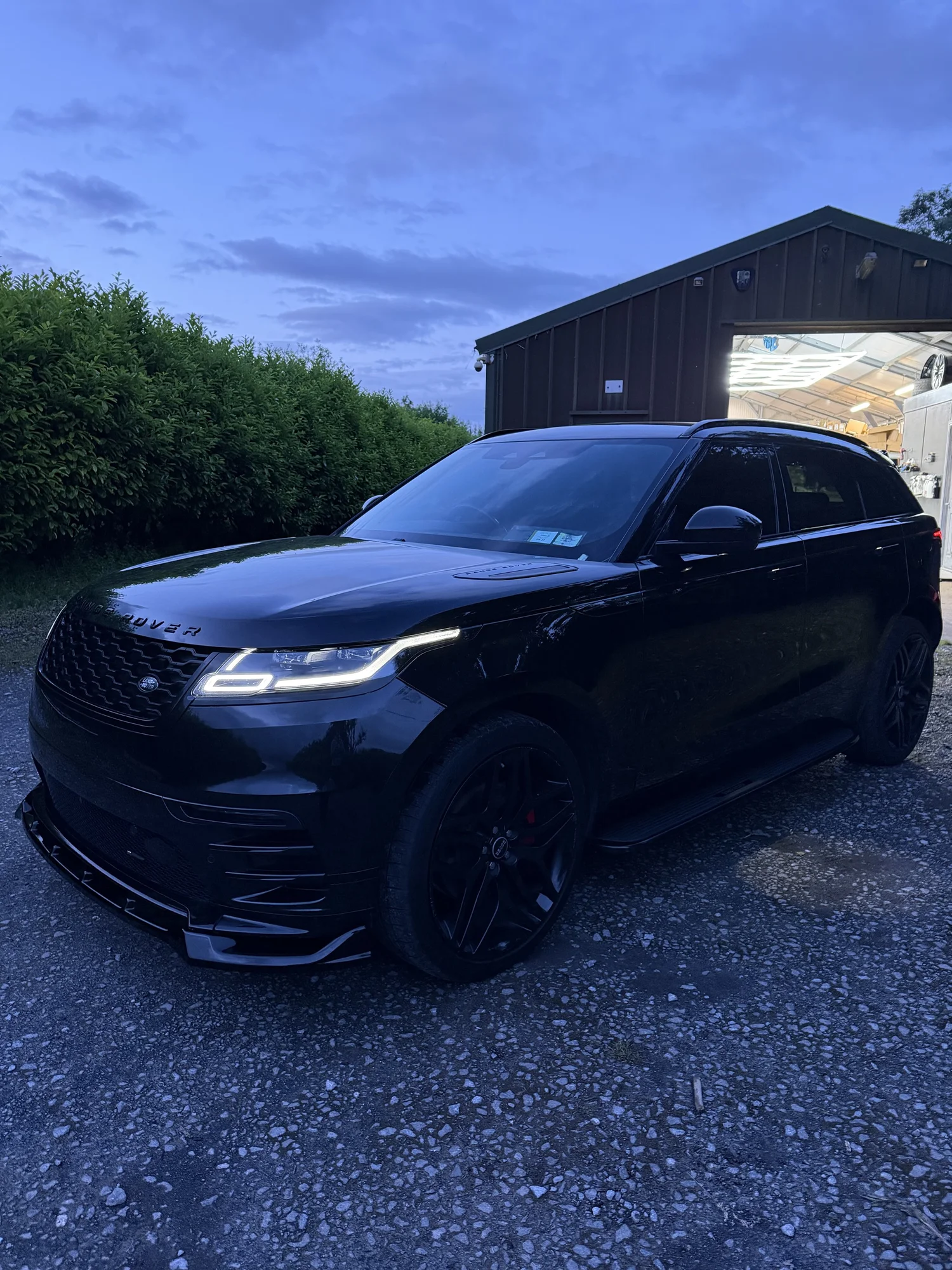 Range Rover Velar front end with body kit and side steps fitted, lights on