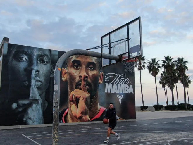 Kevin Sundin, ADHD & Anxiety Coach Specialist playing basketball in Venice Beach California near Kobe Bryant Nike Mamba Mentality Mural wearing Nike Zoom Kobe IV
