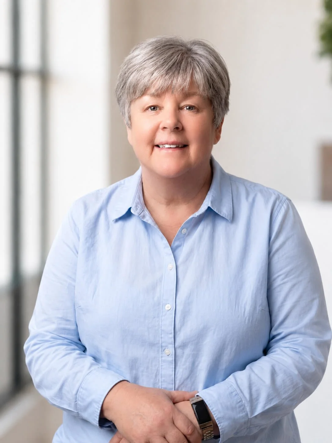 Gill Parkins, PA, a woman with shoulder-length grey hair, wearing a blue shirt.