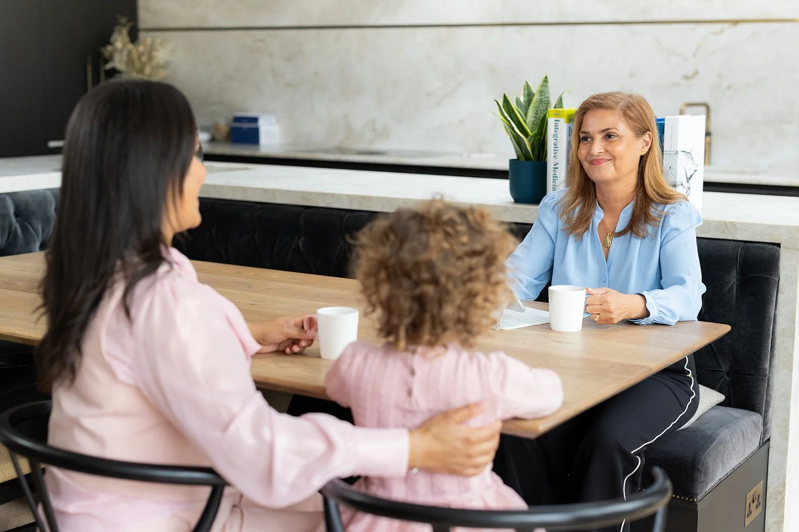 Stella Chadwick, founder of Brainstorm health, having a conversation with a parent and child with unique nutritional needs.
