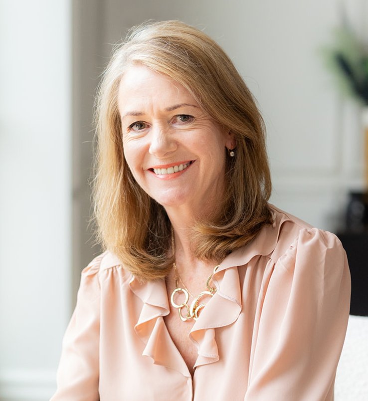 Rachel Calvert-Lee, Registered Nutritional Therapist with shoulder-length hair wearing a pink blouse and gold necklace.
