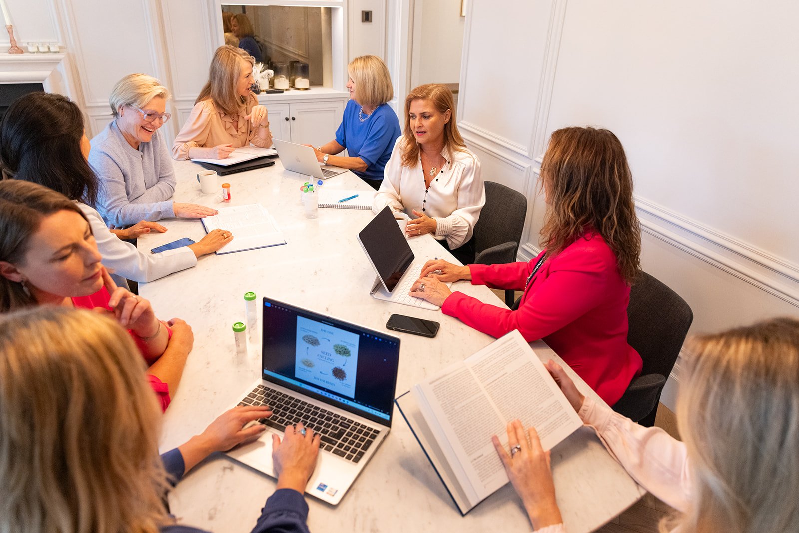 The brainstorm health team gathered around a table discussing a specialist nutritional case.