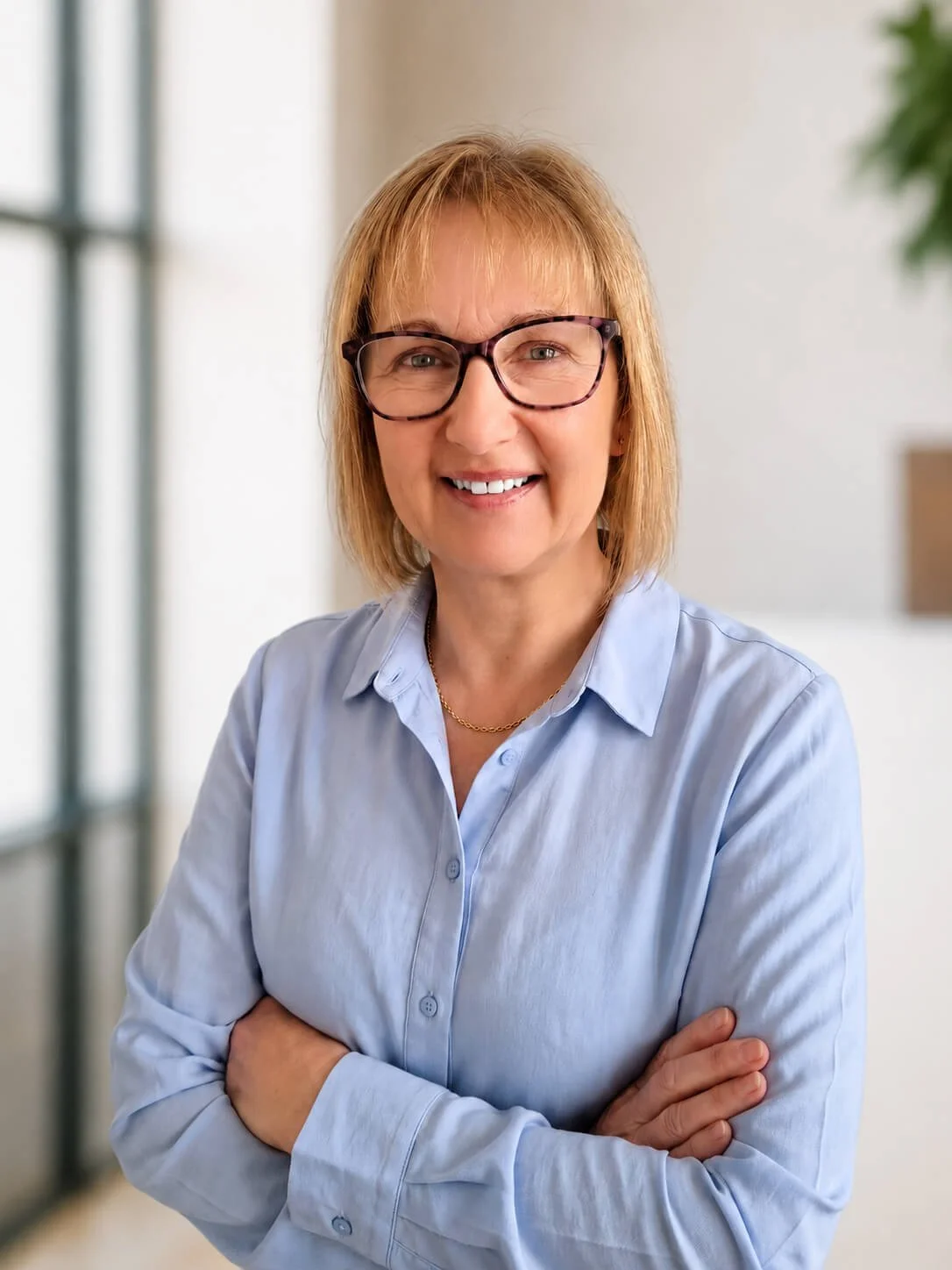 Emma Dadd, a woman with short blonde hair and wearing a light blue shirt..