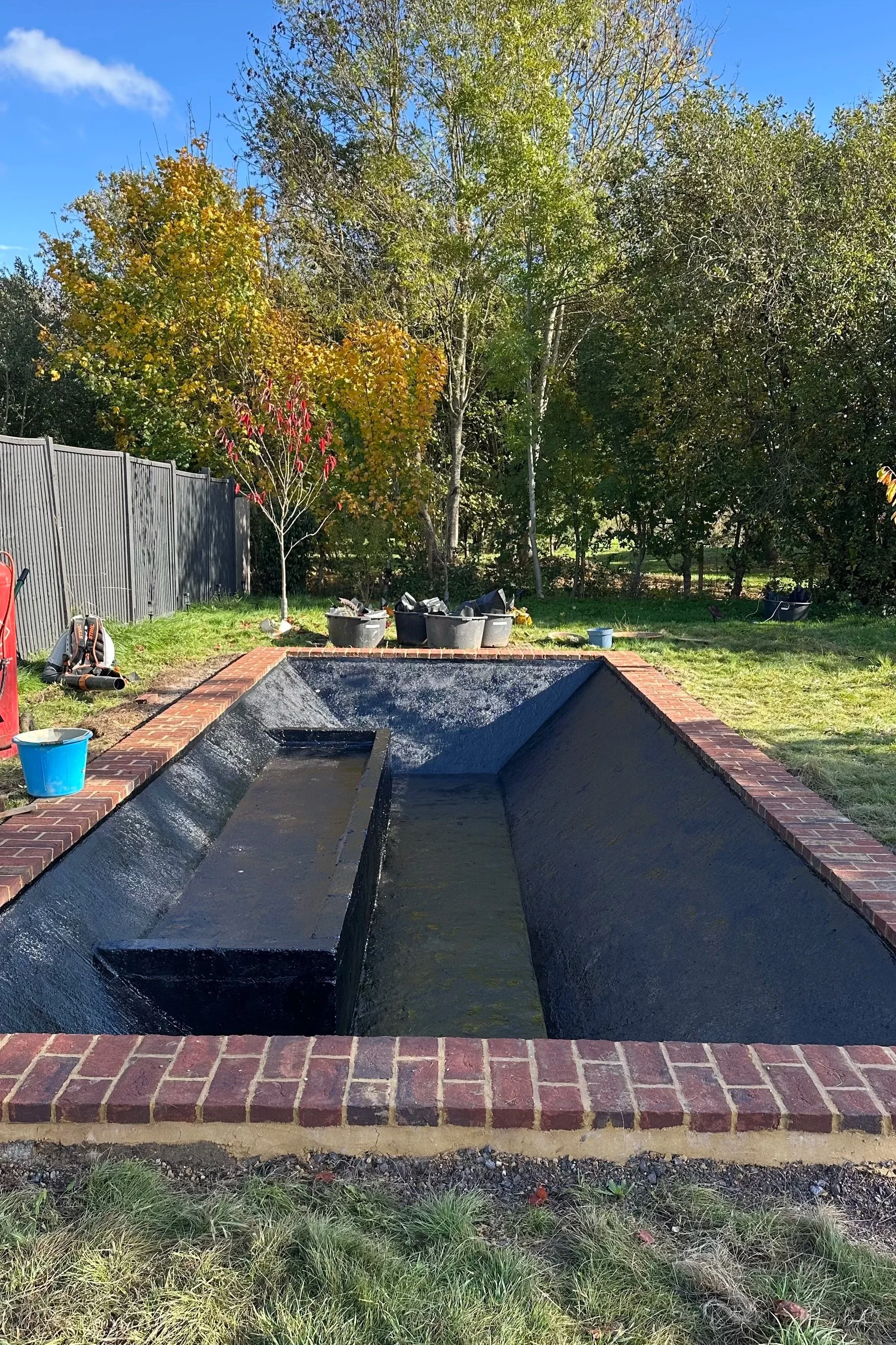 Planting shelf added, black paint for reflecting surface, clay coping to eco terraces
