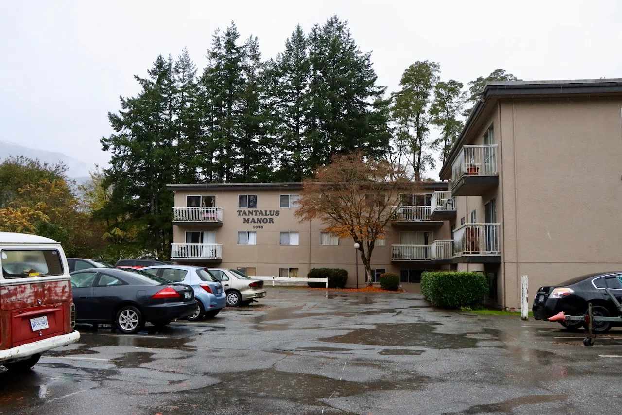 Affordable housing buildings at Tantalus in Squamish before retrofit work begins. NDY Contracting supporting energy efficiency and housing longevity.