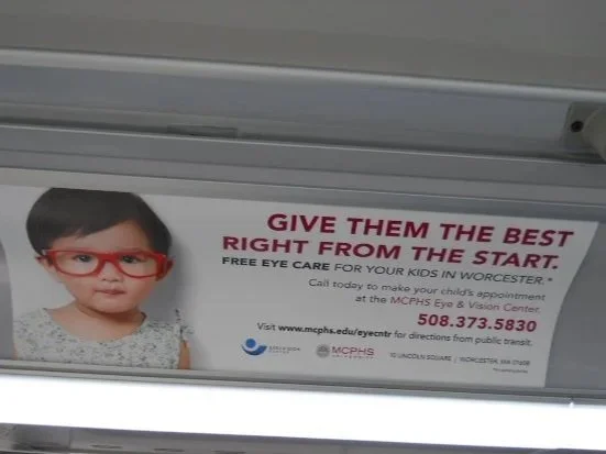 MCPHS Optometry ad inside a bus in Worcester