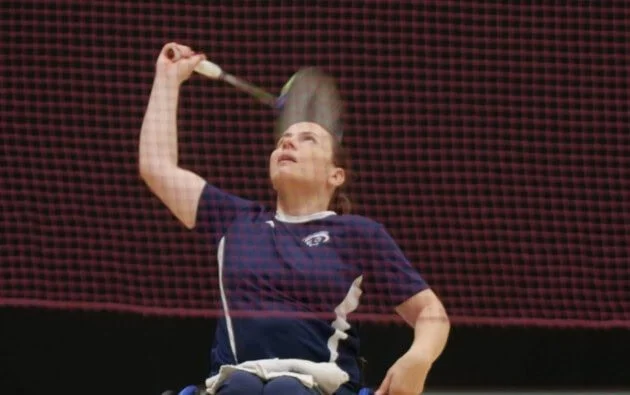 Nina Gorodetsky, competing in badminton, looks up as she is about to hit the birdie in the documentary Nina is an Athlete (2024).