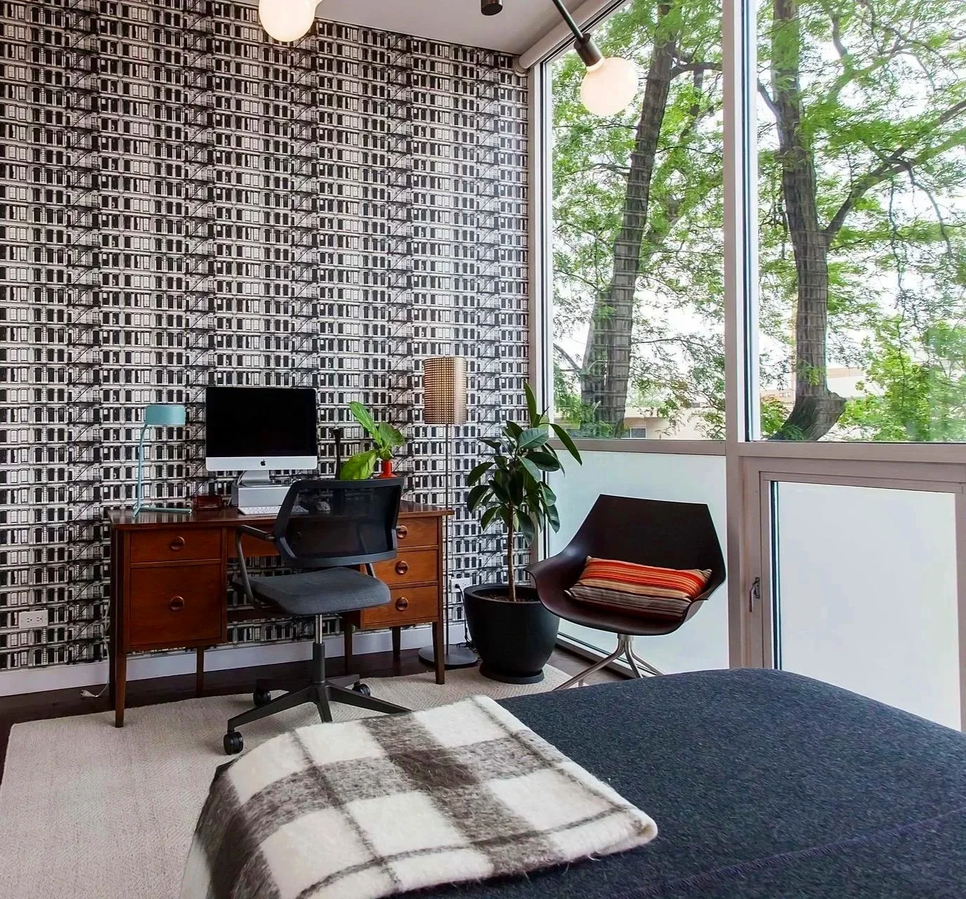 Light-filled Wicker Park home office with graphic wallpaper, mid-century furnishings, and tree-filled views—blending creativity and function with modern style.