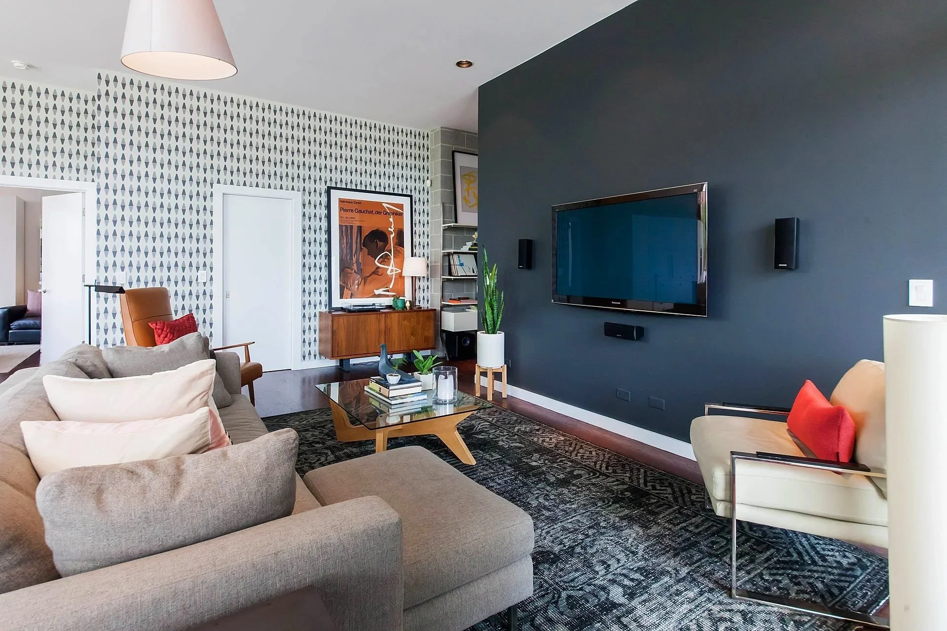 Modern Wicker Park living room with bold accent wall, graphic wallpaper, and mid-century furnishings, designed as a vibrant mix of comfort and character.