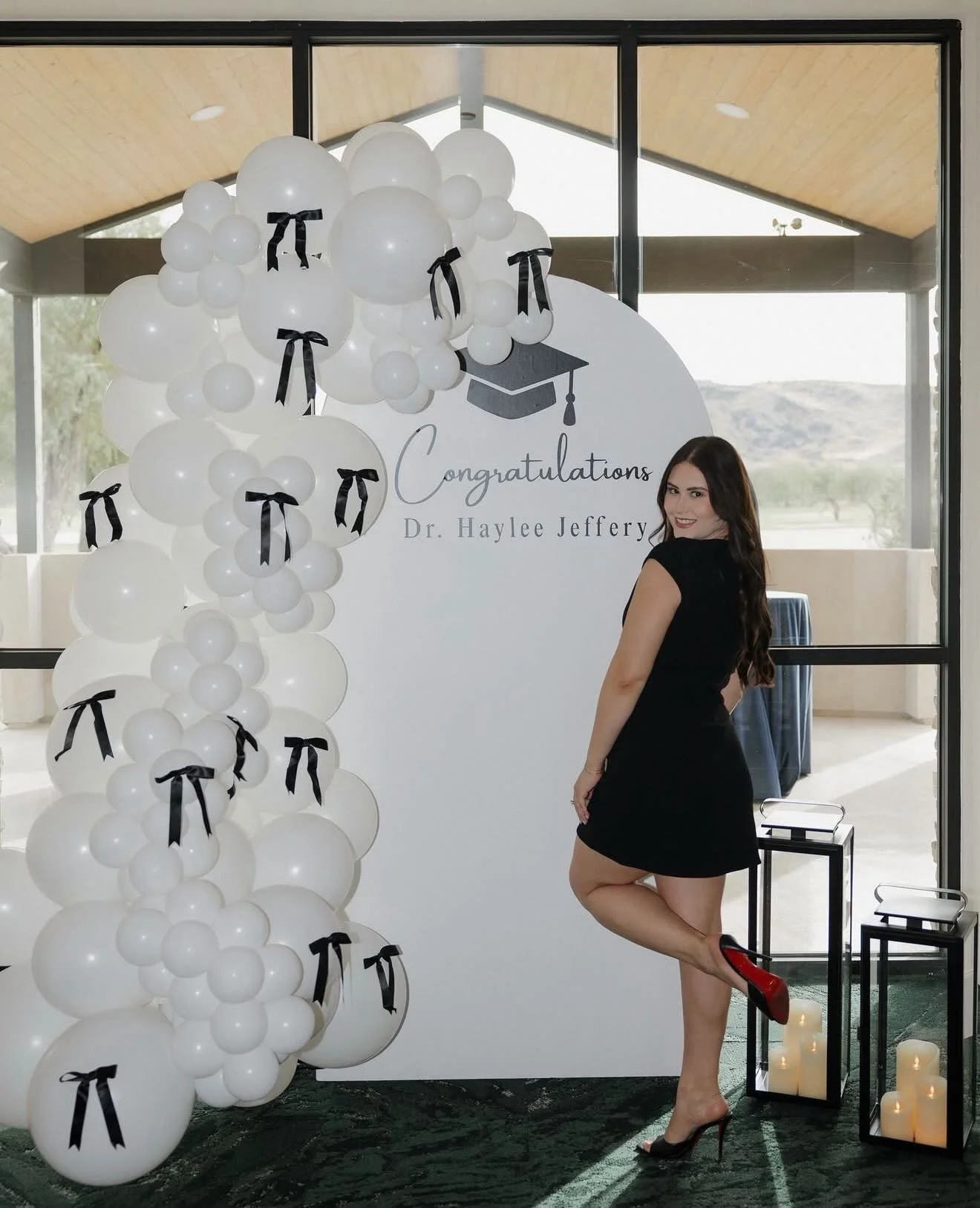 A graduation backdrop for the most beautiful doctor 🎓🤍

This elegant graduation setup featured an all-white organic balloon garland accented with delicate black bows and a personalized graduation sign created especially for Dr. Haylee Jeffrey. The 