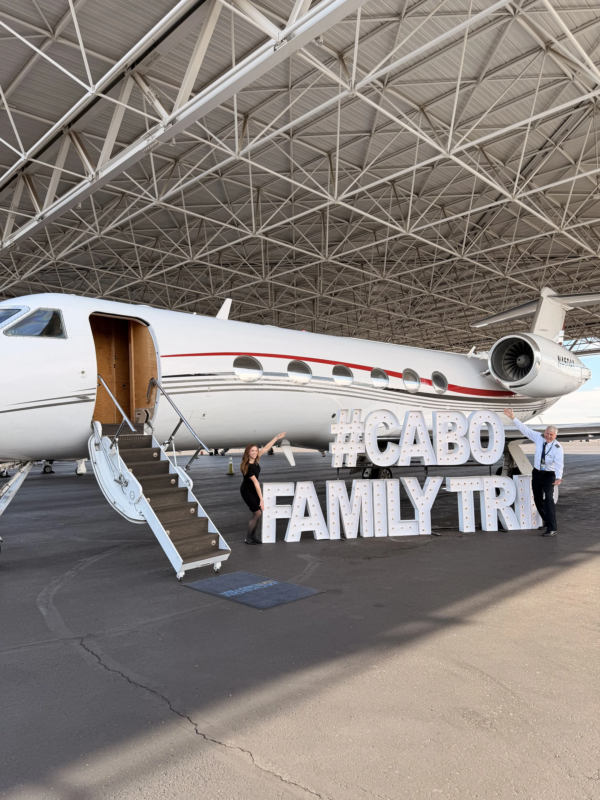 Custom marquee letter installation featuring "Cabo Family Trip" signage displayed in front of a private aircraft inside a luxury aviation hangar. Designed for VIP travel experiences, private jet events, corporate activations, family celebrations, and