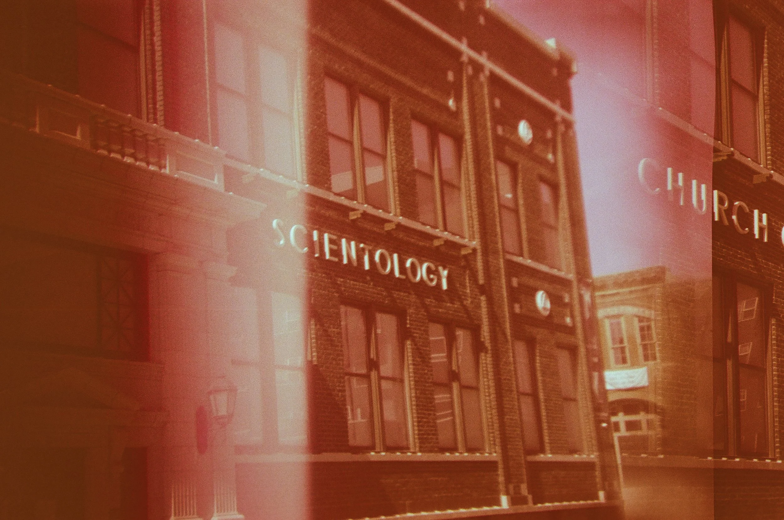 Sign on a brick building reads 'SCEHNOLOGY' with some letters partially obscured, likely meant to spell 'TECHNOLOGY'.