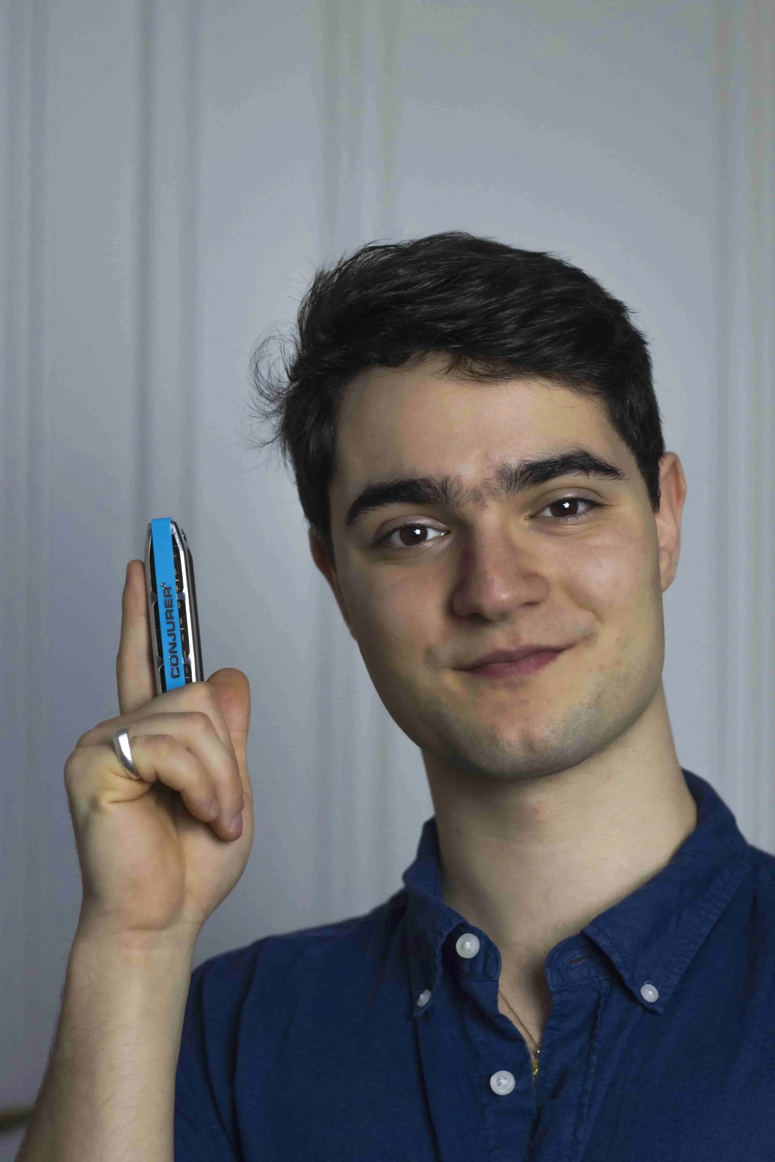 Portrait von Bluesharp Lehrer Bruno Doblhofer mit einer Mundharmonika in der Hand