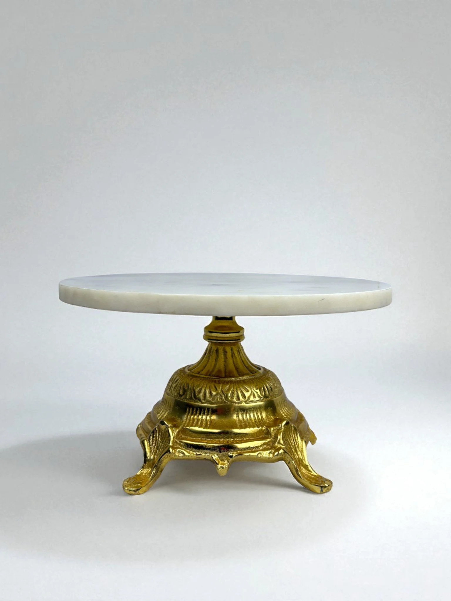 Image of cake stand in a Hollywood Regency Style, made from Marble with a gold color base