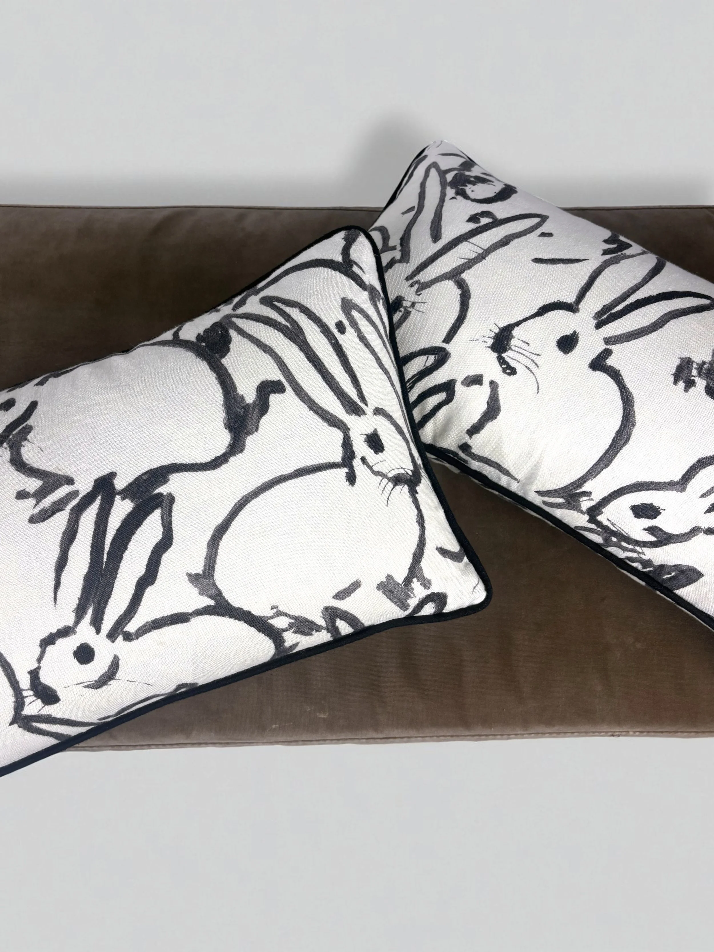 Image of handmade lumbar pillows, featuring a gorgeous black and white rabbit design by artist Hunt Slonem.