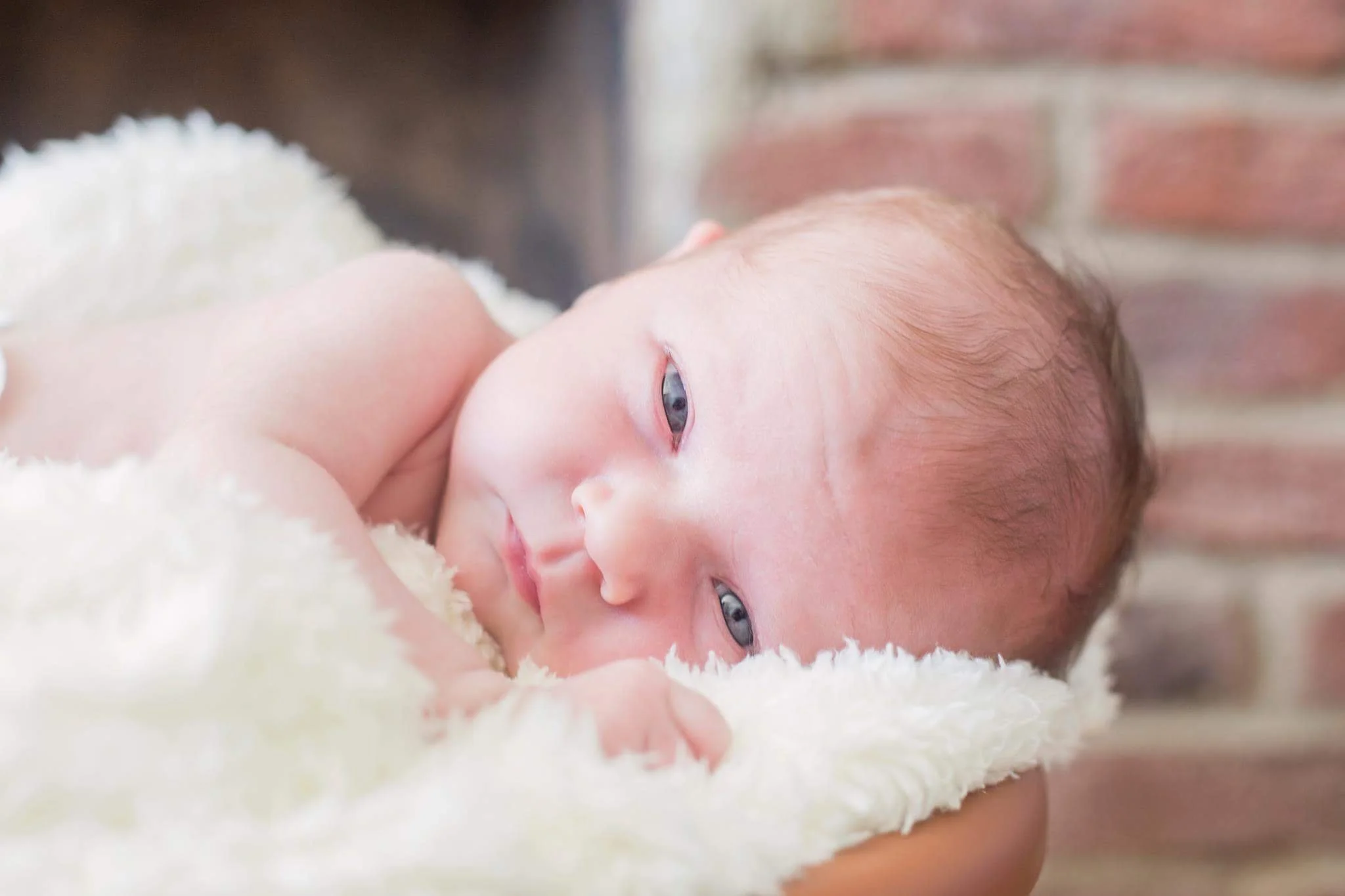 Baby looking into the camera with eyes wide open