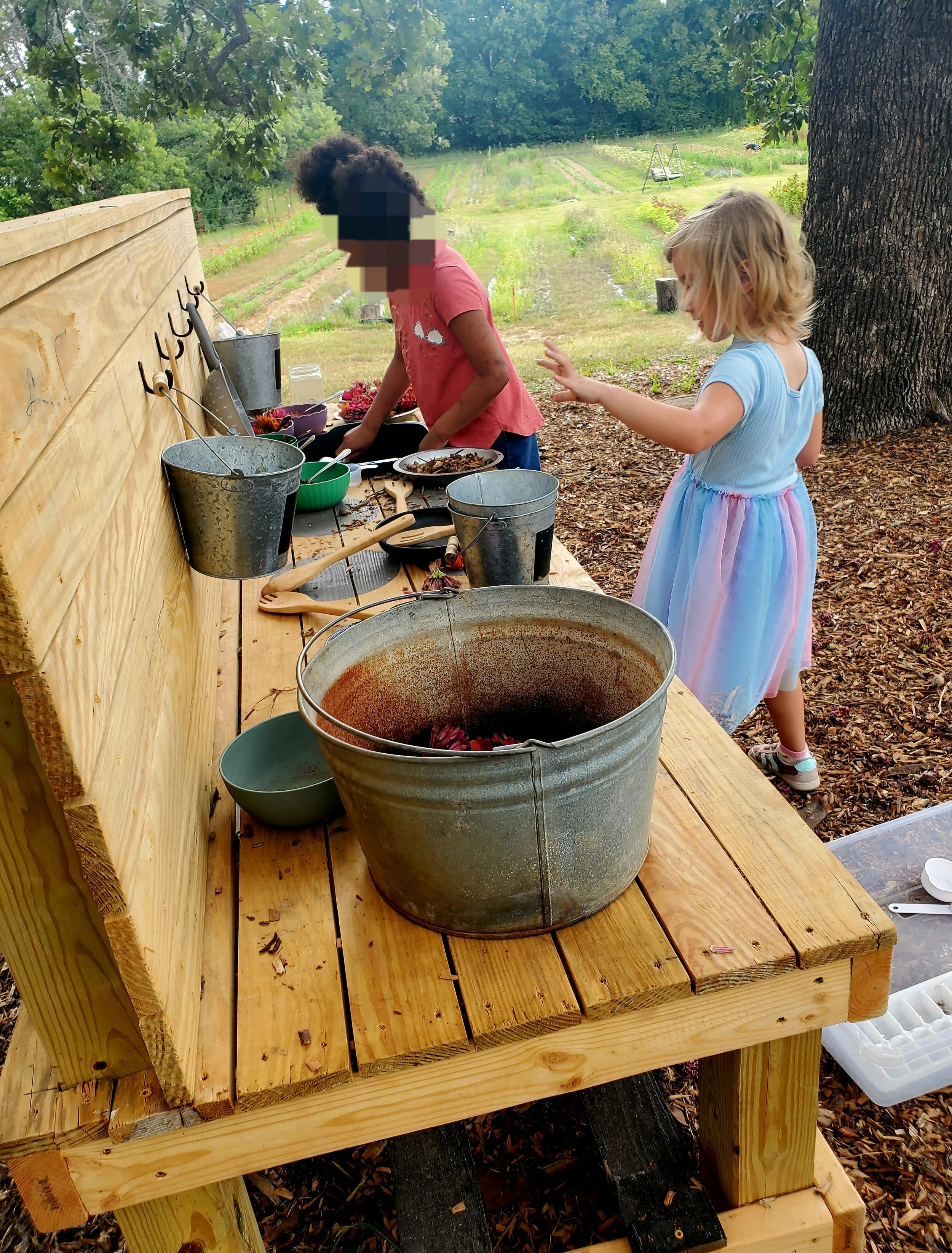 Creative cooking at The Flower Meadow's mud kitchen
