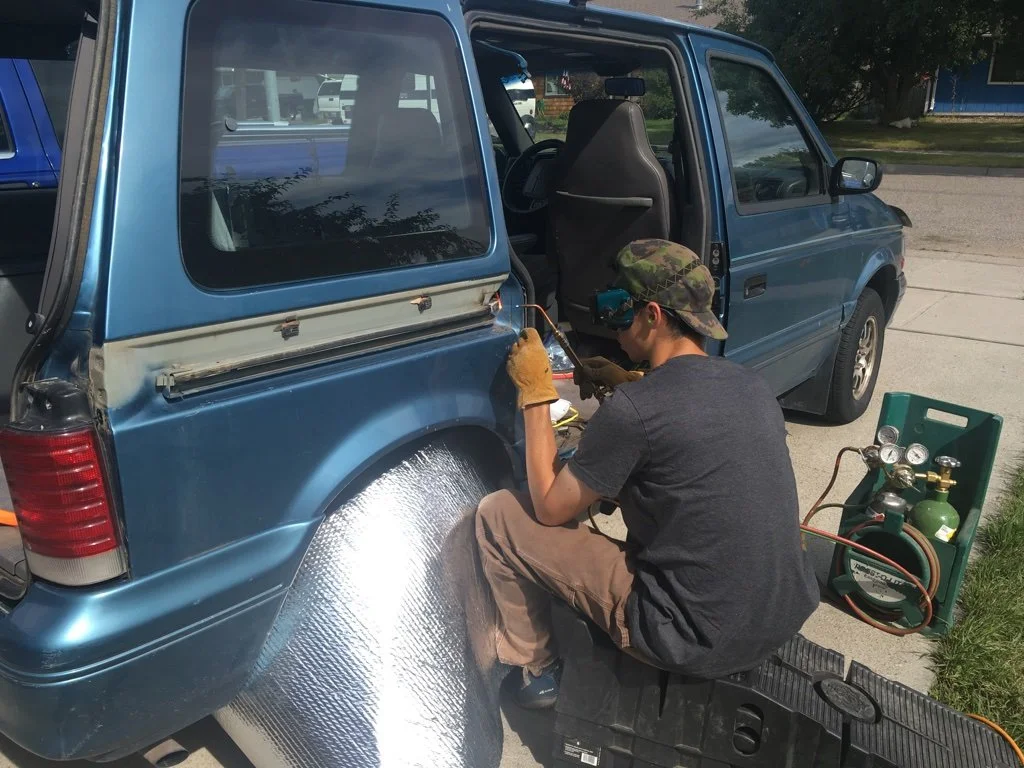 Oliver fixing the sliding door track on Vincent Van-go.