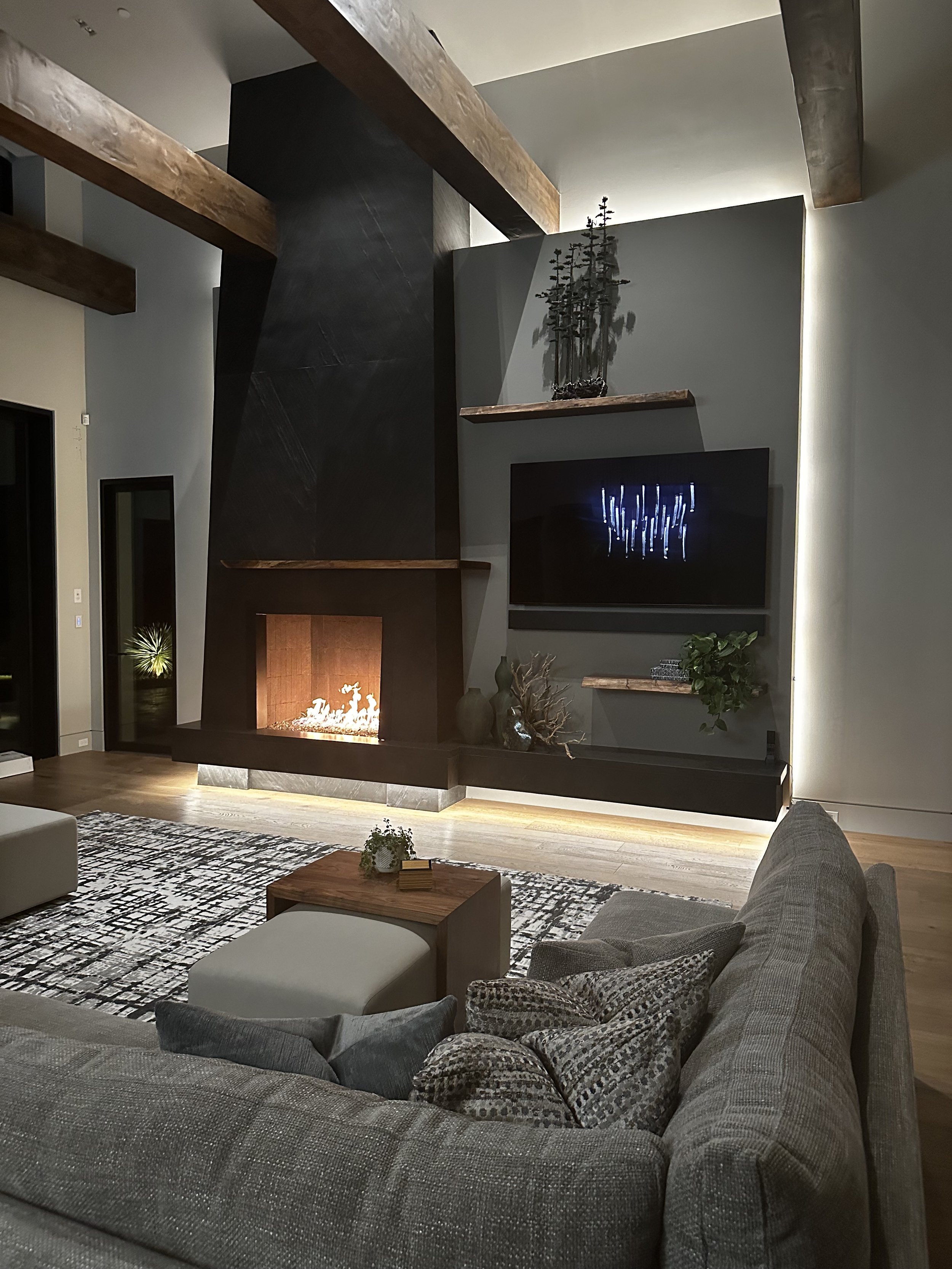 Moody modern living room, Tapered fireplace, wood tones, warm feeling, floating beams
