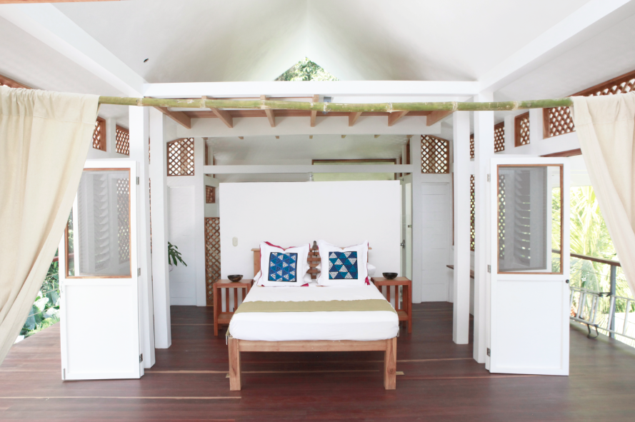 A cozy bedroom featuring a bed with an elegant canopy draped above it, creating a serene atmosphere.