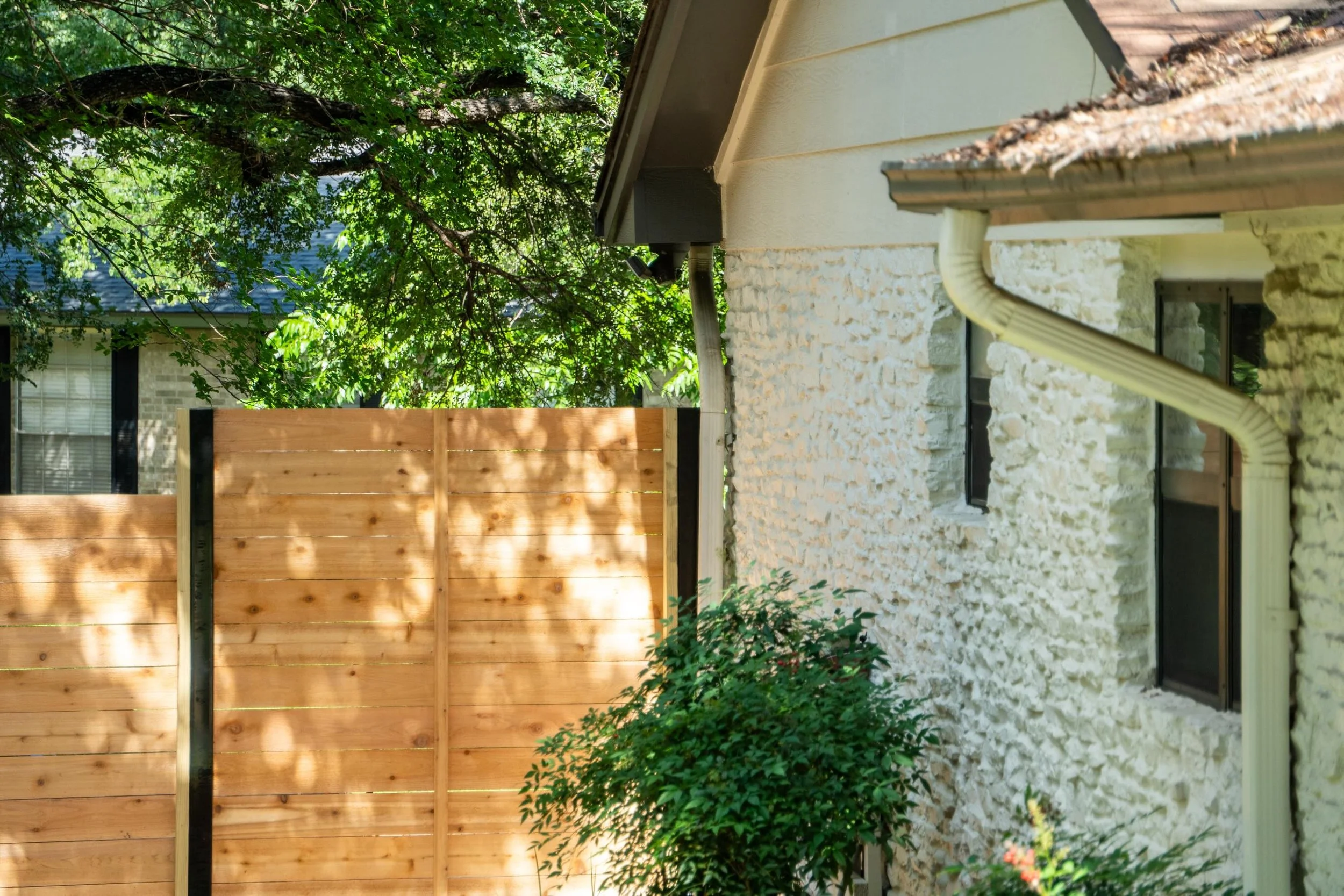 Sloped yards are an interesting challenges to work through, and this one had some serious grade changes.

The existing vertical fence had been leaning for a while. So we pulled it out and replaced it with a horizontal privacy fence using western red 