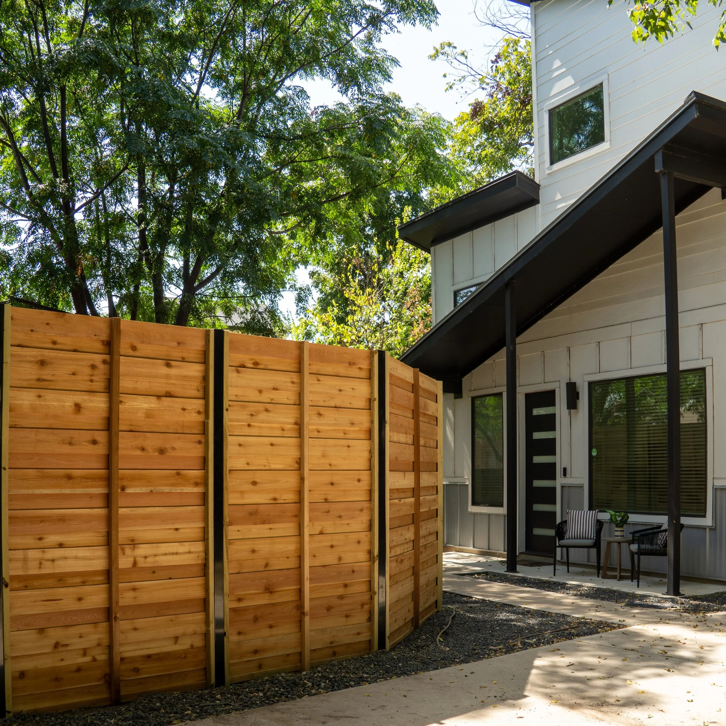This is a horizontal board-on-board fence, built with Western Red Cedar (of course) and black powder-coated steel posts.

With board-on-board, the cedar overlaps instead of meeting edge-to-edge. Besides giving you true privacy as the wood naturally e