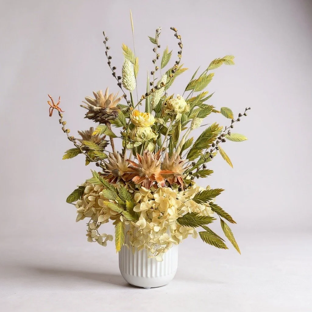 Neutral dried arrangement in a ribbed white vase with hydrangea, grasses and seed pods. Everlasting, handcrafted in Brisbane
