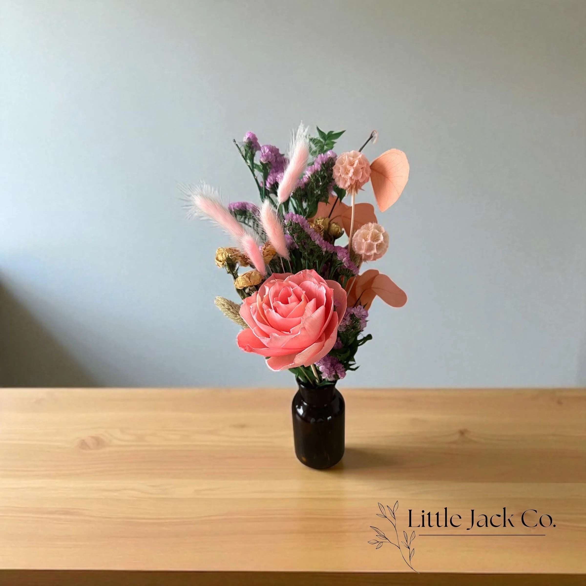 Elegant dried flower arrangement featuring bunny tails, statice, scabiosa and a handmade rose