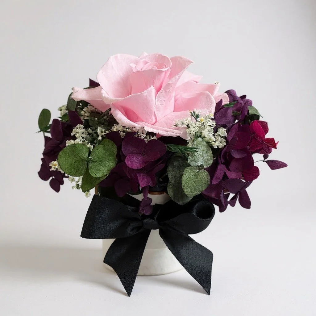 Mini hatbox pink and purple dried flower arrangement with black ribbon