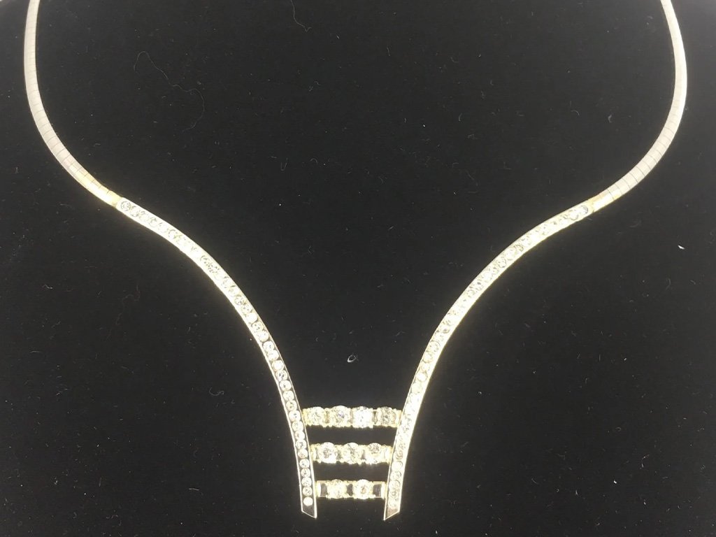 A diamond necklace on a black display background.