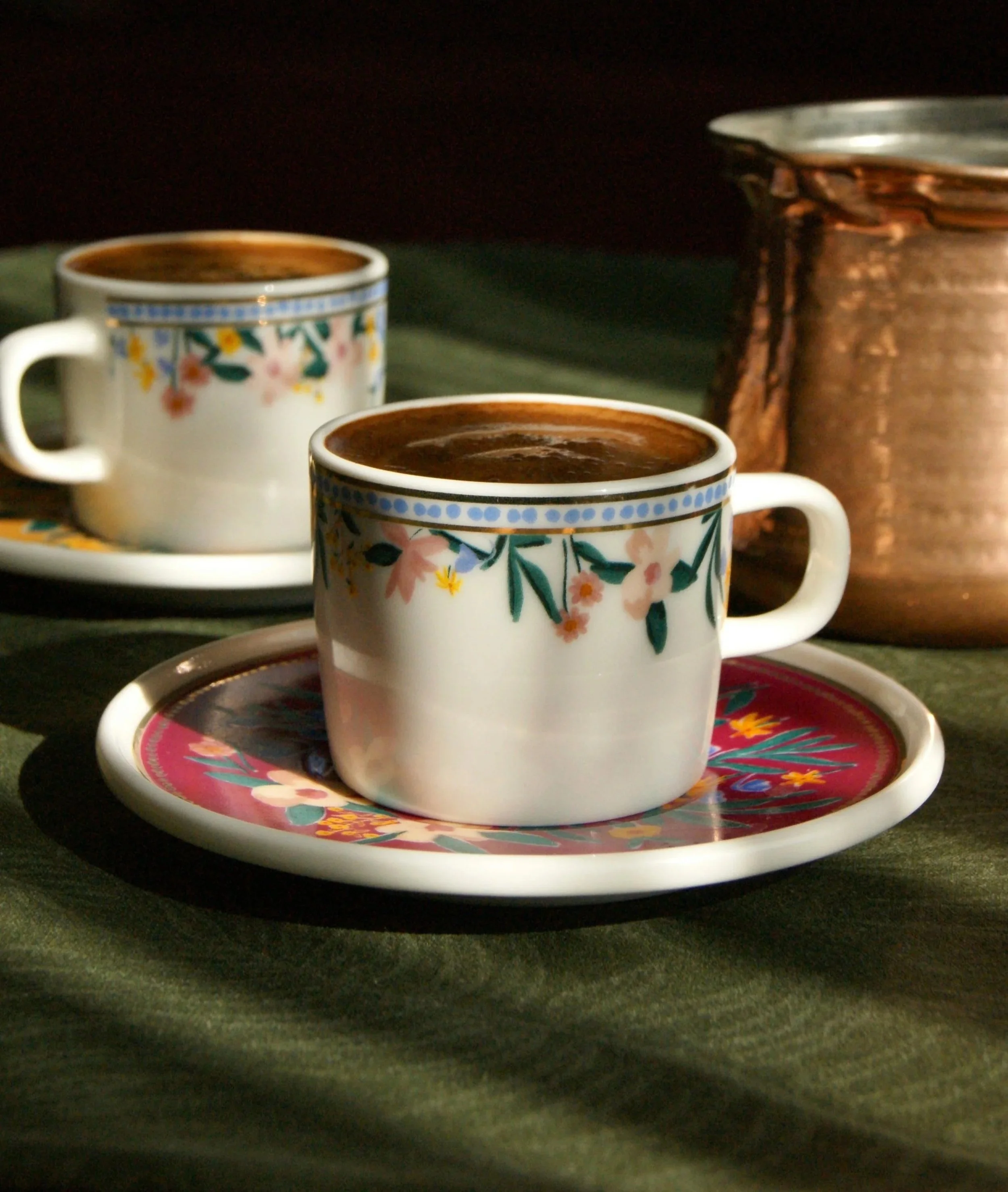 Two coffee mugs on a plate, representing connection and two different cultures allowed in therapy.