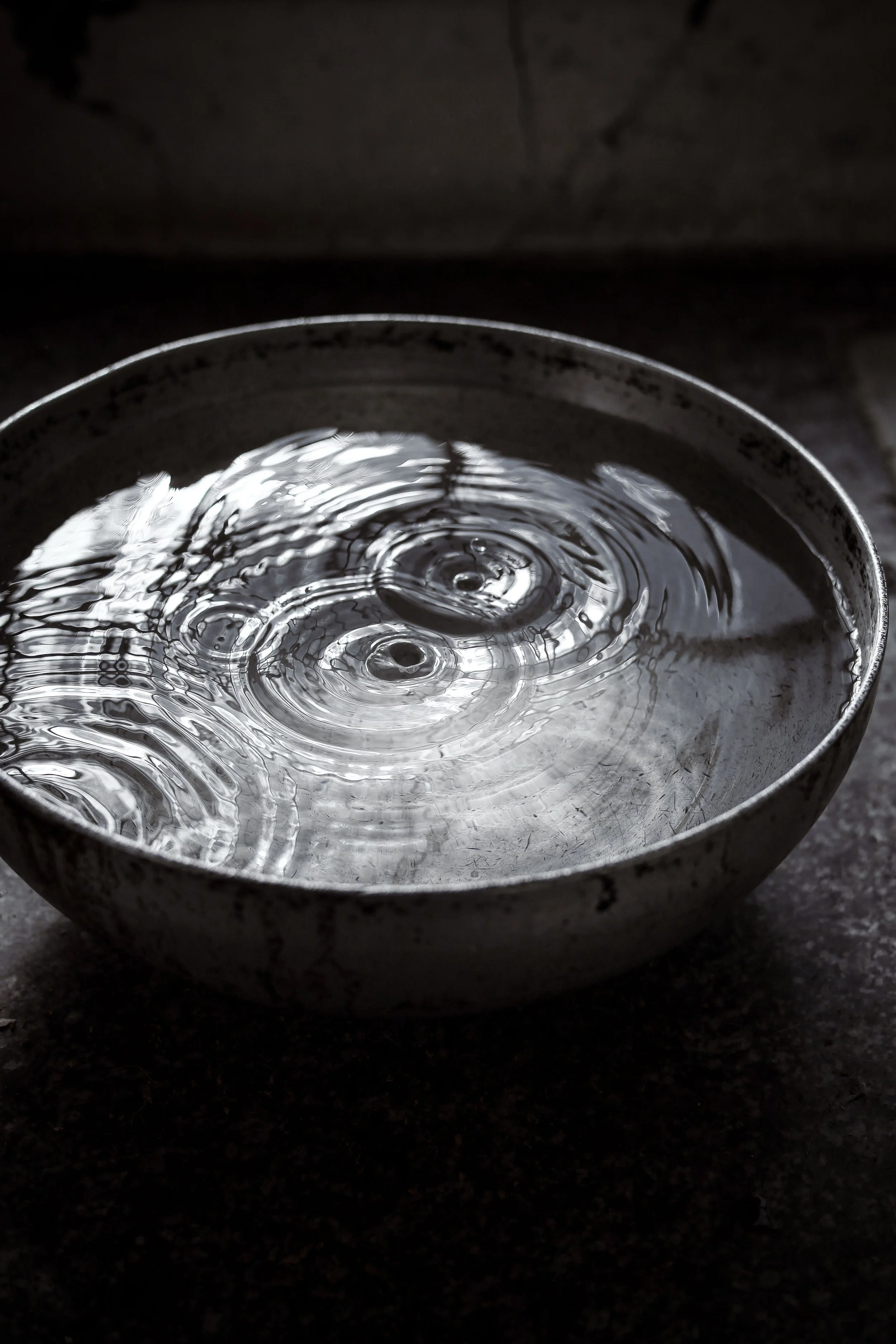 Ripples in a metal cup, representing managing stress and finding internal peace during individual and couples therapy.