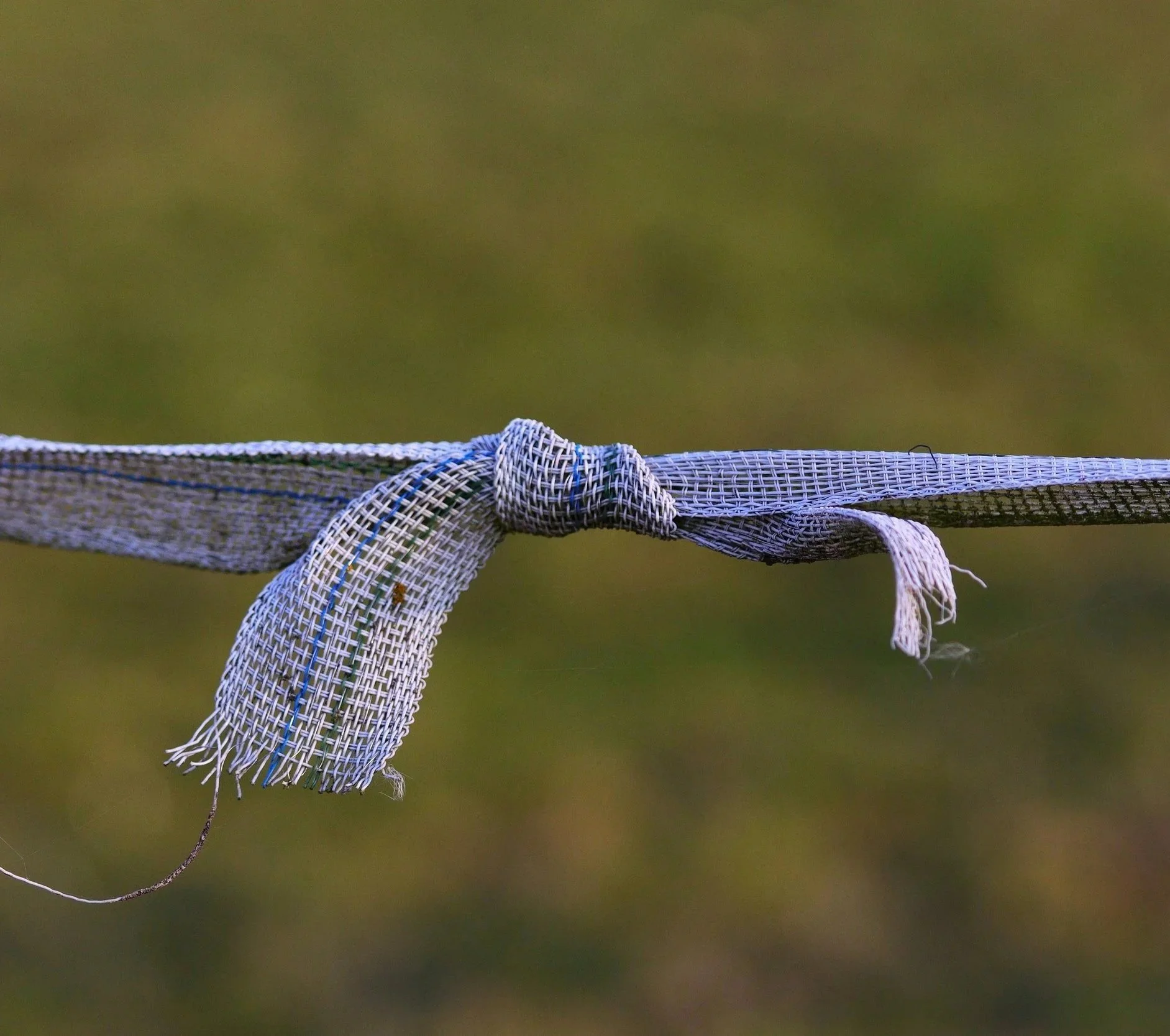 A frayed knotted cord, representing feeling like you are barely hanging on, completely exhausted, or caught in defensive loops.