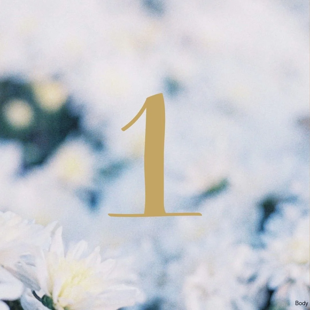 Number 1 in gold font overlay on a blurred background of white flowers and soft blue sky