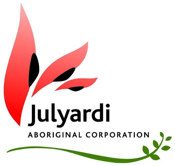 Logo of Julyardi Aboriginal Corporation with stylized red and black leaf design, green underline, and text.