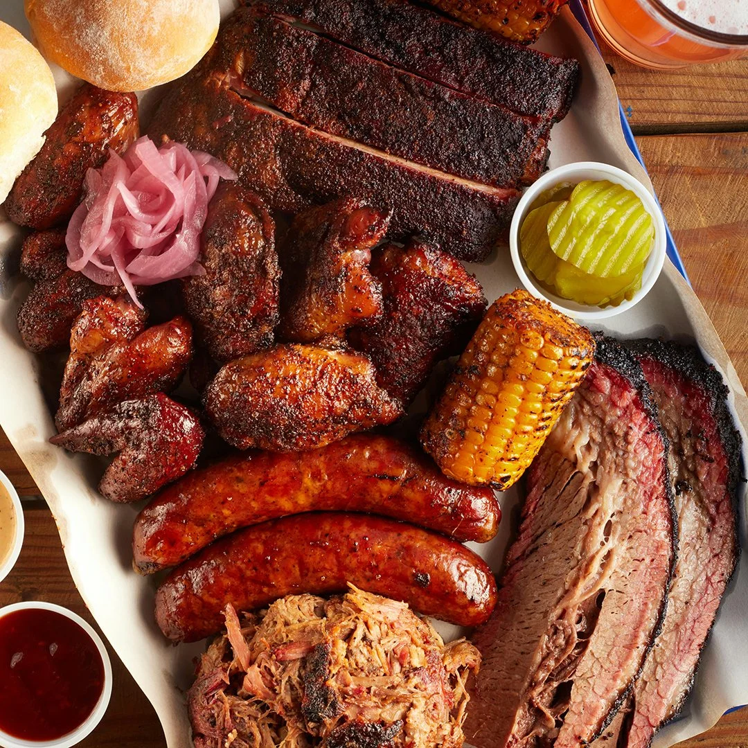 Photo of a mixed platter of BBQ meats and sides