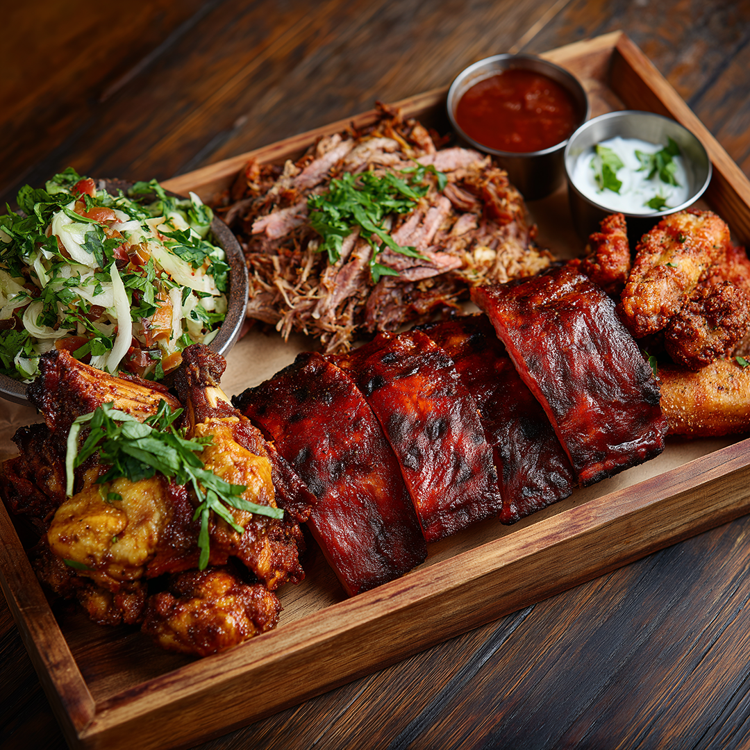 A tasting platter of BBQ meats and sides
