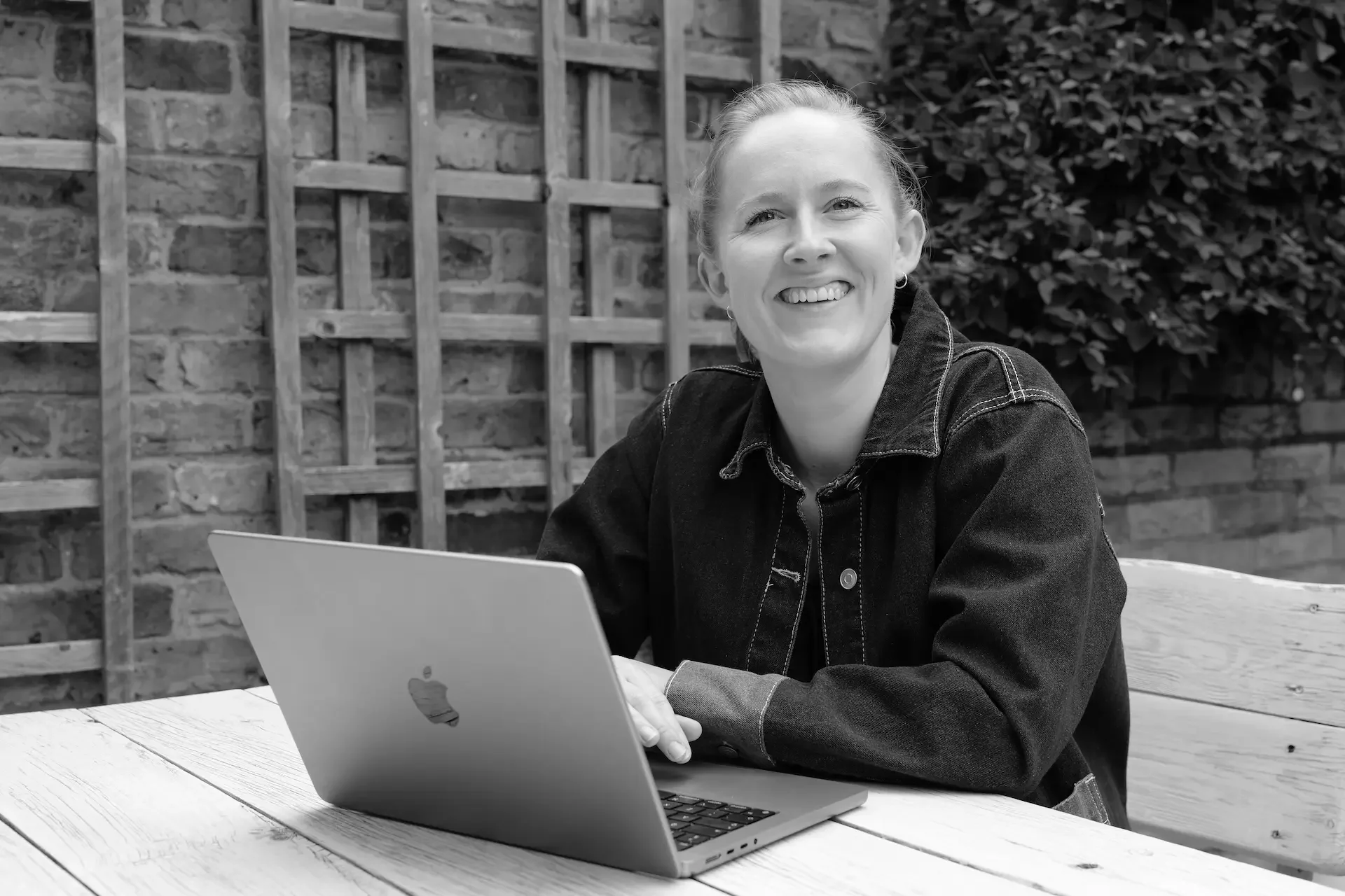 Beth at her laptop smiling