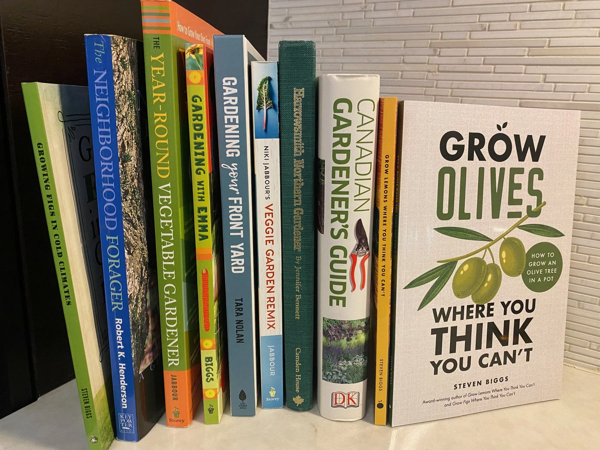 Gardening books by Canadian authors arranged on a table.