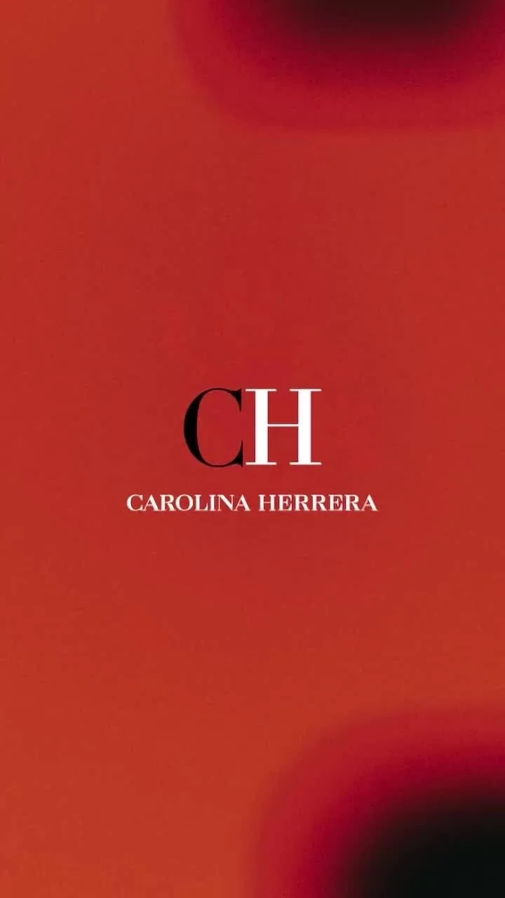 Book cover with a red background, large black and white initials 'CH', and the author's name, Carolina Herrera, in white text.