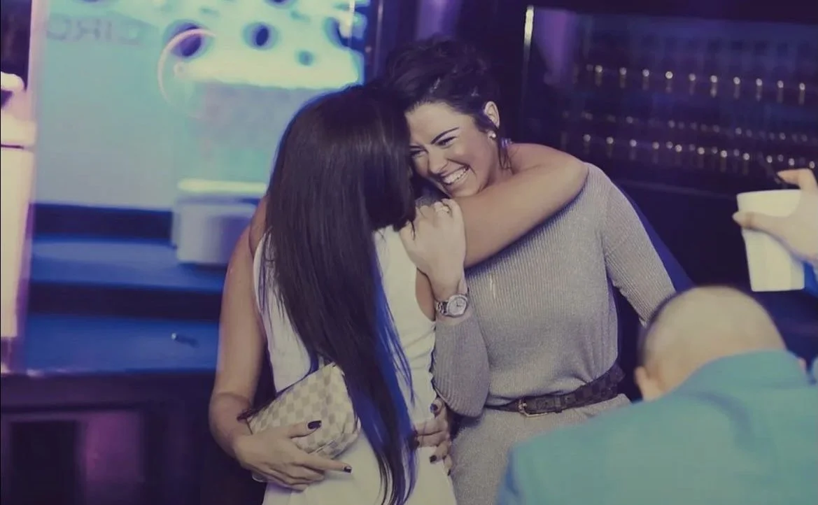 Friends hugging at a nightclub in Leeds
