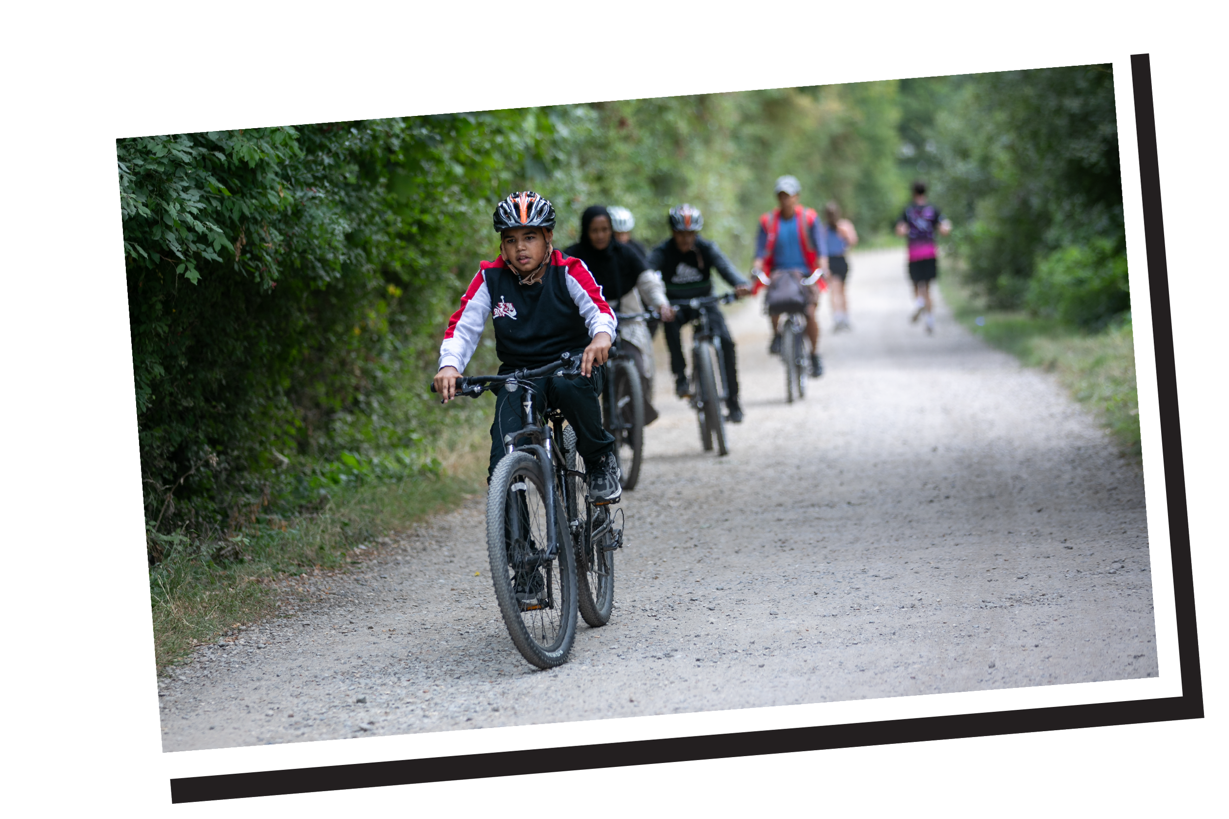 Group of children cycling through the woods
