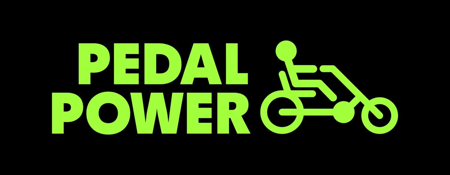 The image is the Pedal Power logo which is a black background with green text and stick figure riding a bike
