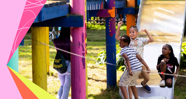 The image shows children playing outside near a slide