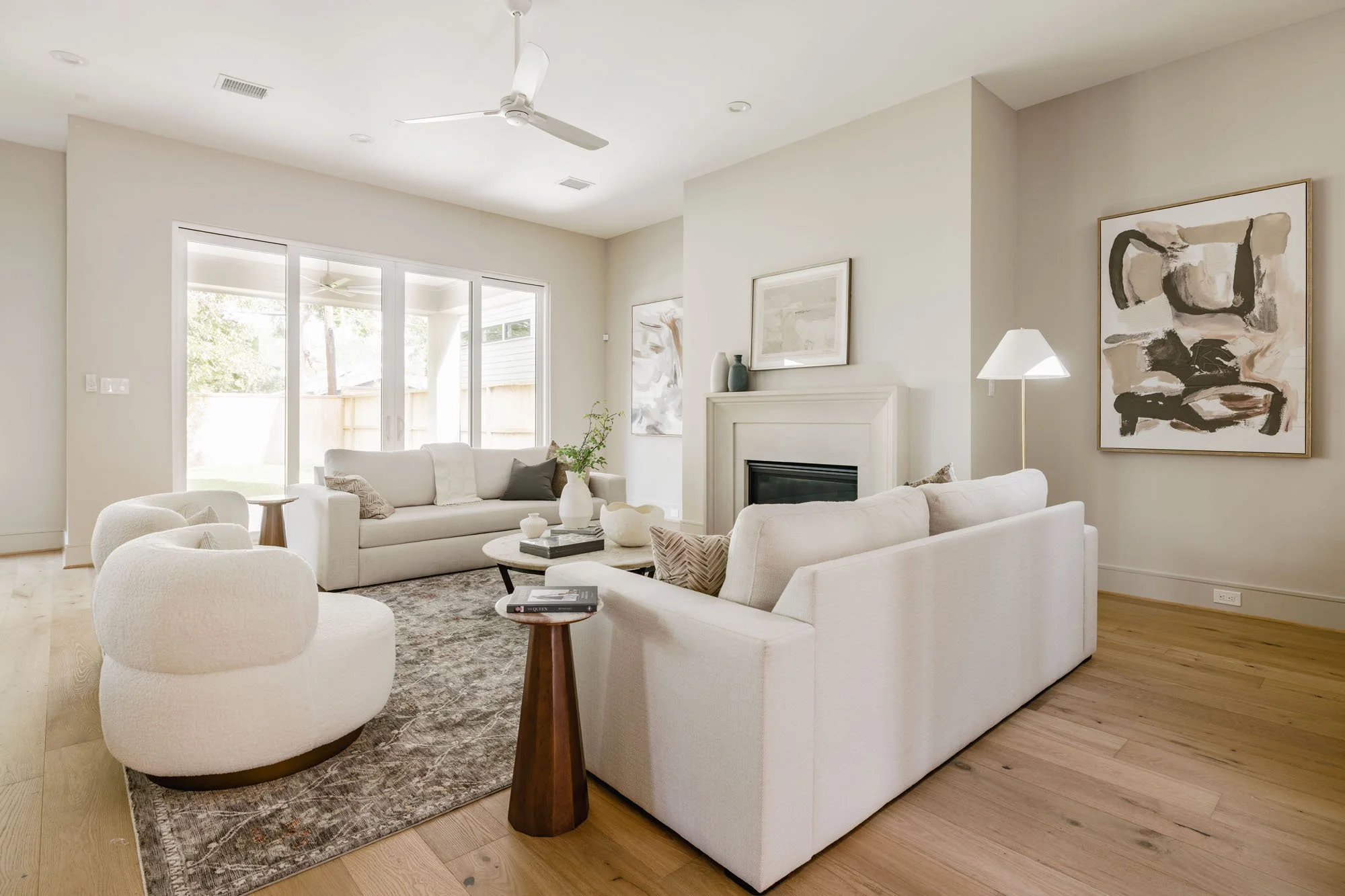 Open living room with sliding glass doors to the covered patio and a cast stone fireplace