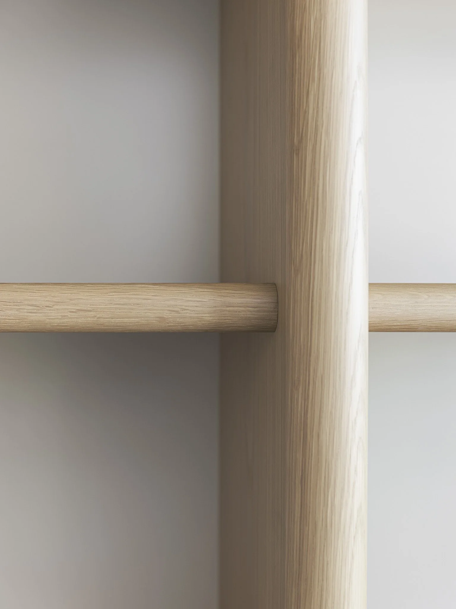 Close-up photo of a light-colored wooden shelf bracket with natural wood grain visible, mounted on a white wall.