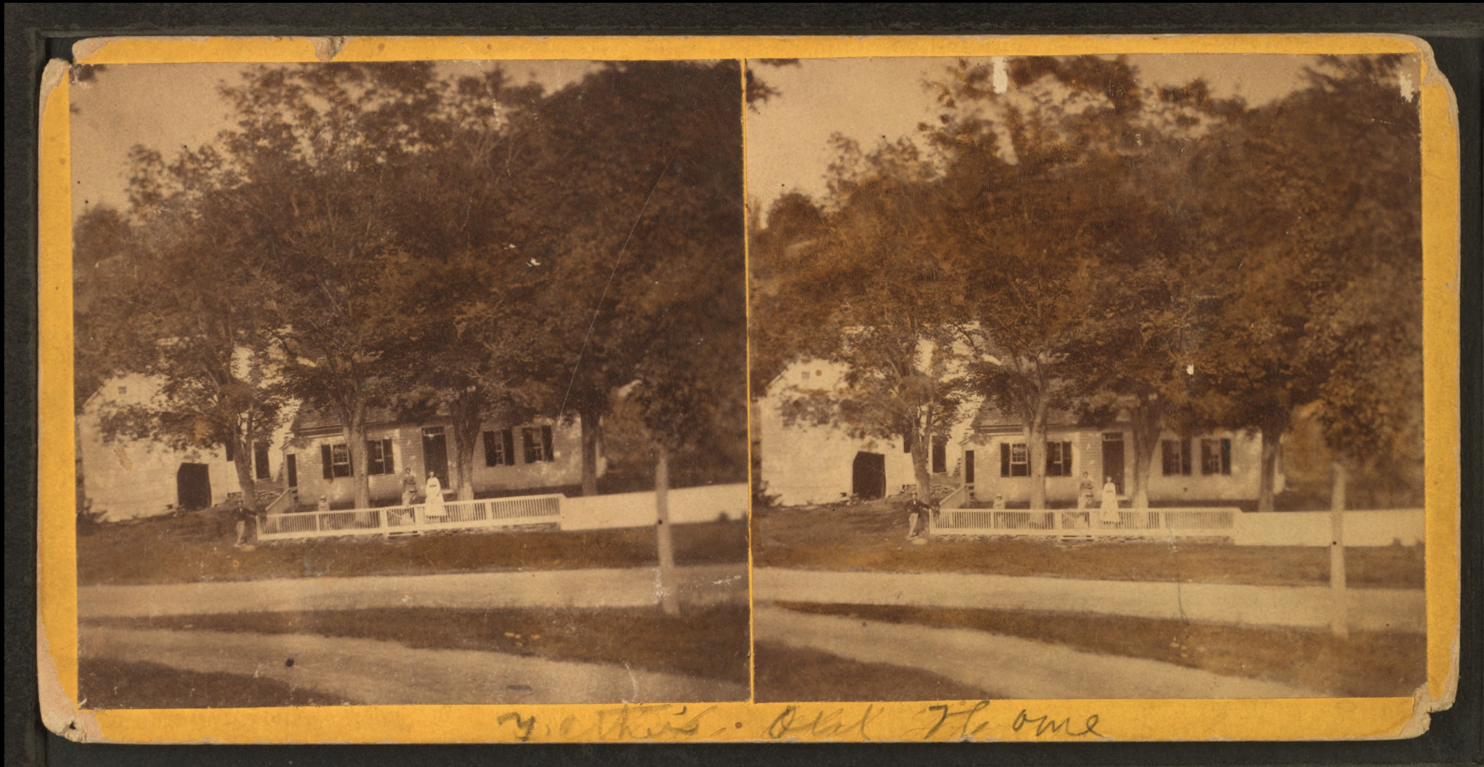 A sepia-toned stereoscopic photograph of a house with several large trees in front. There is a picket fence with two women standing inside it, and a child standing outside. The photo has handwritten notes at the bottom, reading 'Y. C. Thies' and 'Bel