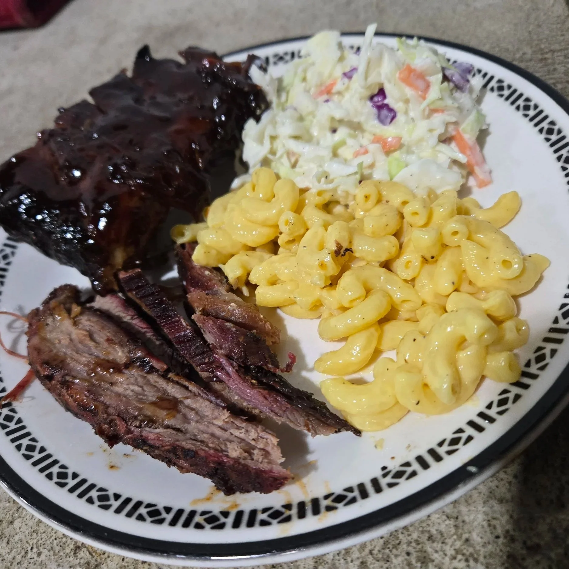 Plate with barbecue ribs, macaroni and cheese, and coleslaw