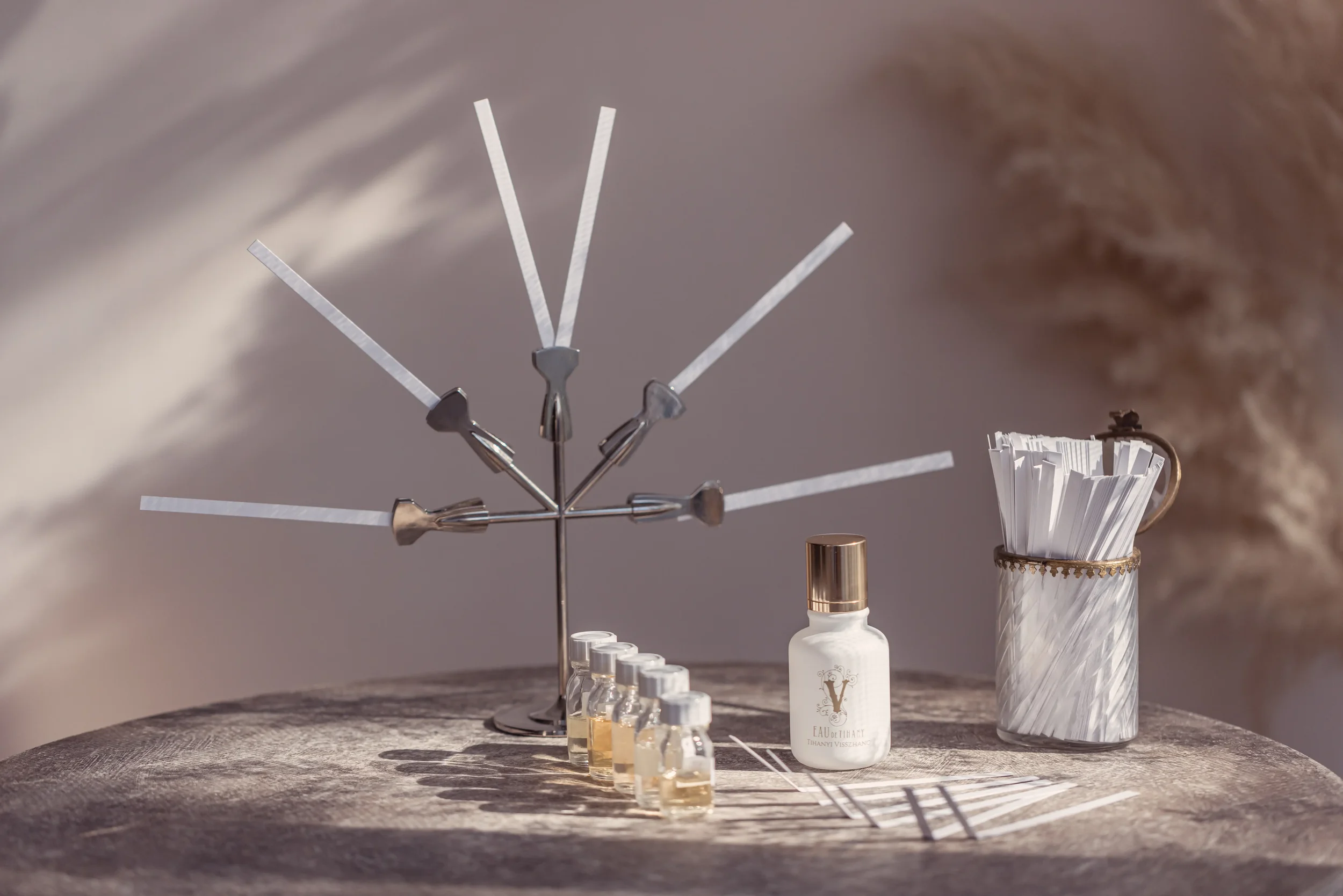 Professional fragrance design atelier featuring perfume formulation vials and scent strips for bespoke olfactory branding and custom perfume consultations.