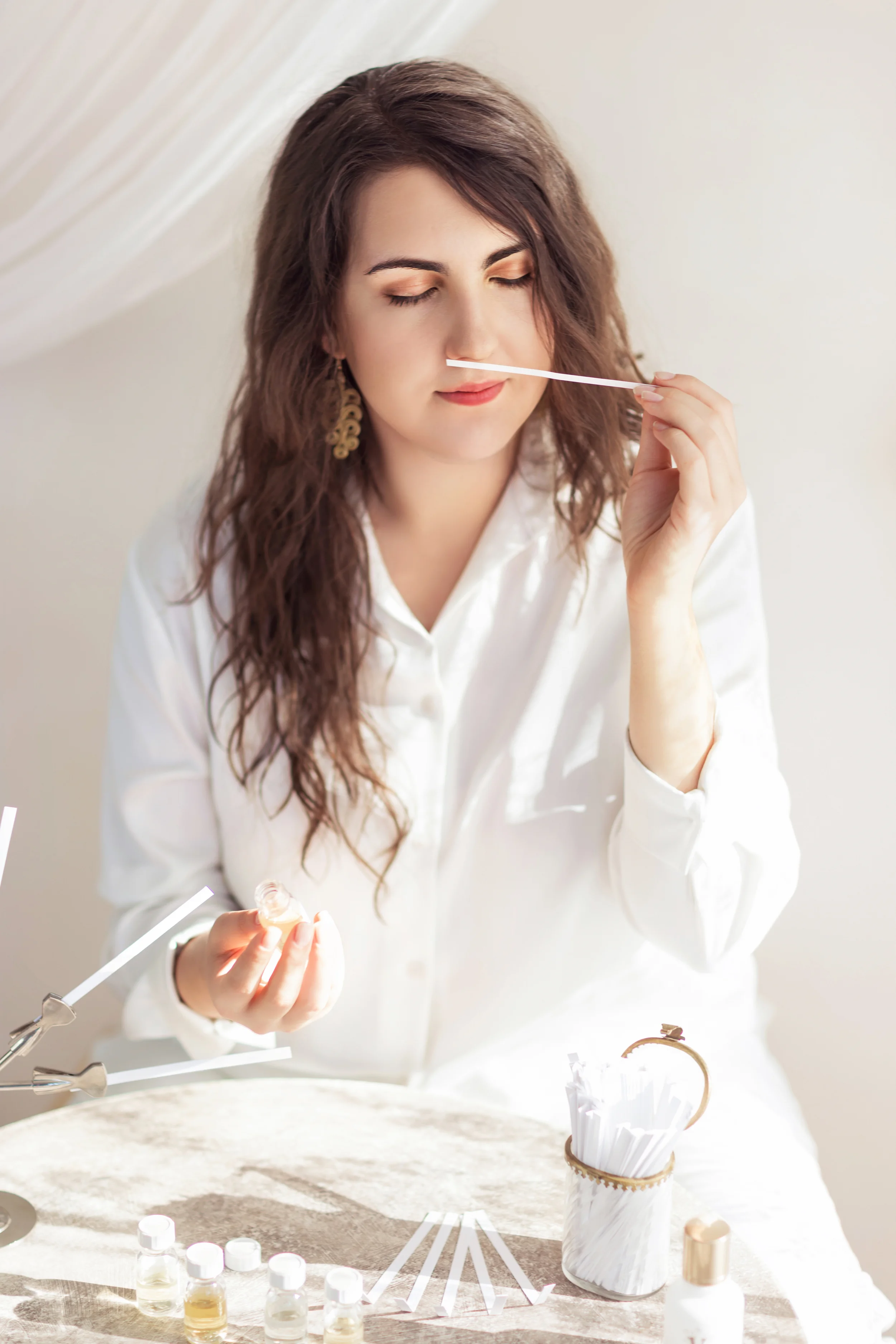 Junior perfumer Nyárádi Natália performing a professional sensory evaluation during the fine-tuning of a signature fragrance composition.